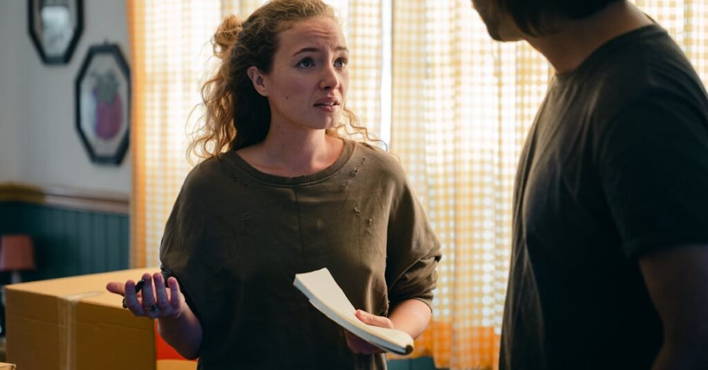 A couple engaged in a conversation while preparing to move in a warmly lit living room.